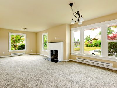 Empty room with carpet and fireplace