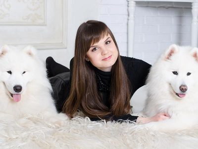Woman with dogs on white carpet